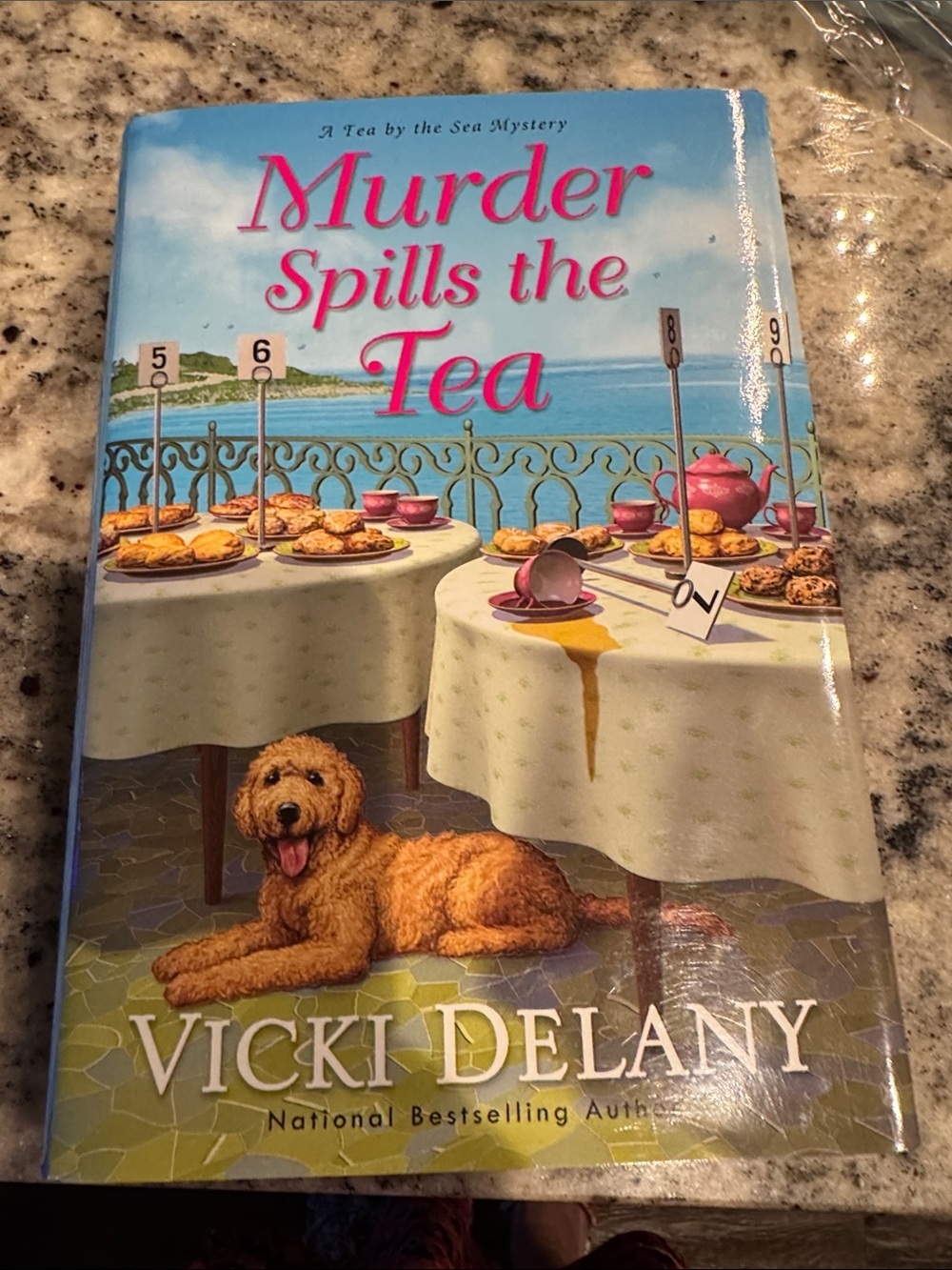 Murder Spills the Tea by Vicki Delany - Bright Illustrated Cover